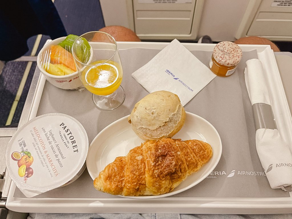 breakfast offered on air nostrum business class, including croissant, bread, a selection of fresh fruits and yogurt