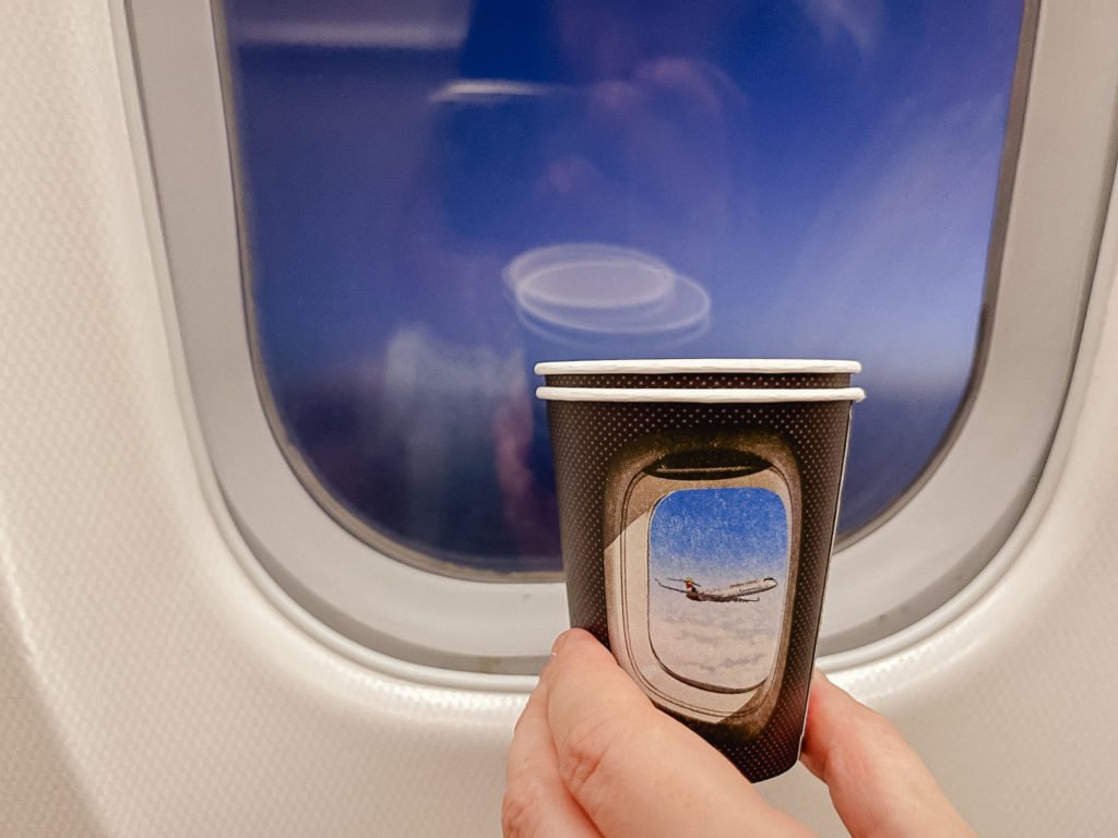 Coffee cup with an airplane window