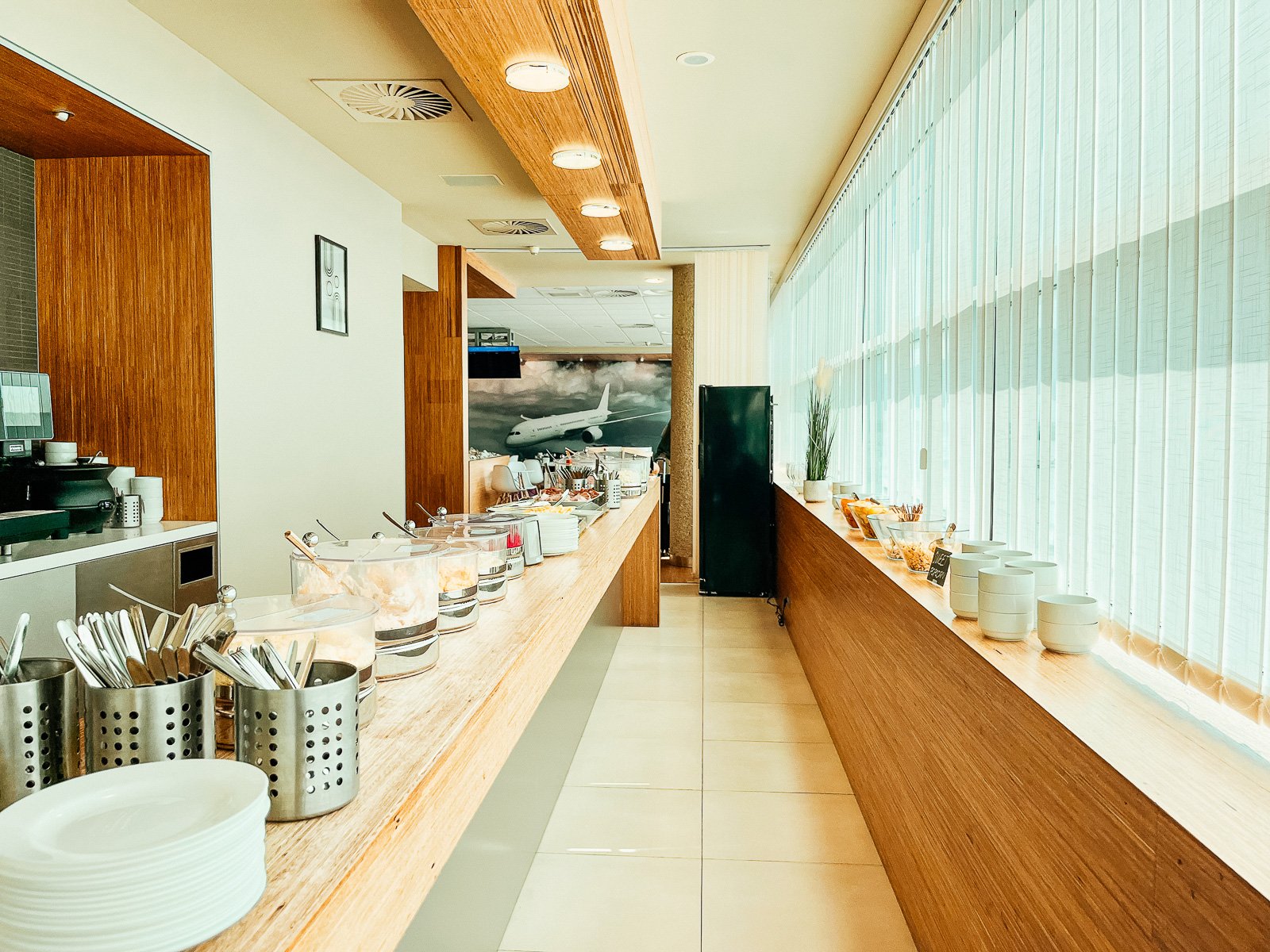 Lounge buffet area with salads, cold meats, bread and snacks. 