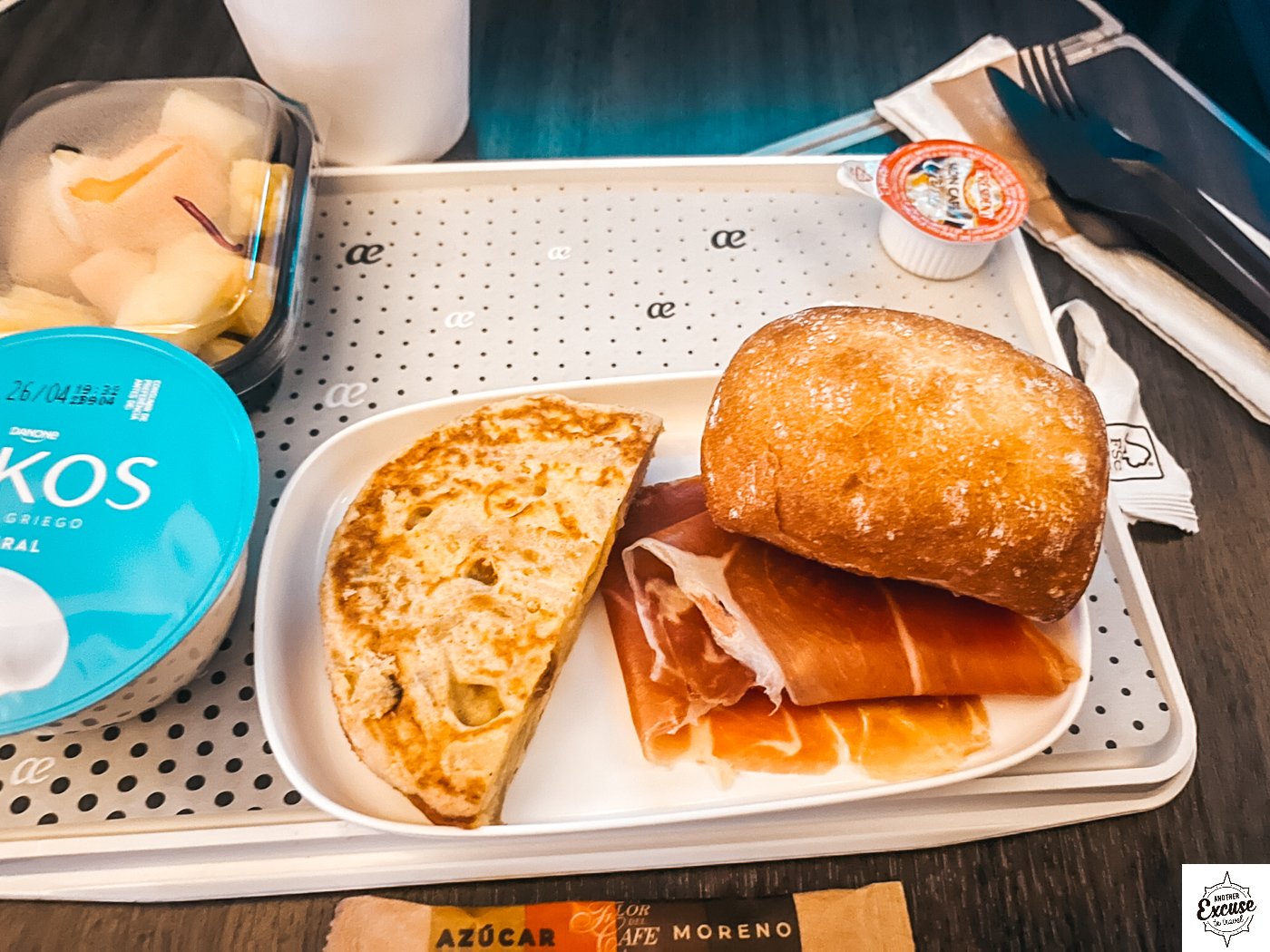 flight breakfast close-up with bread, ham, and spanish tortilla