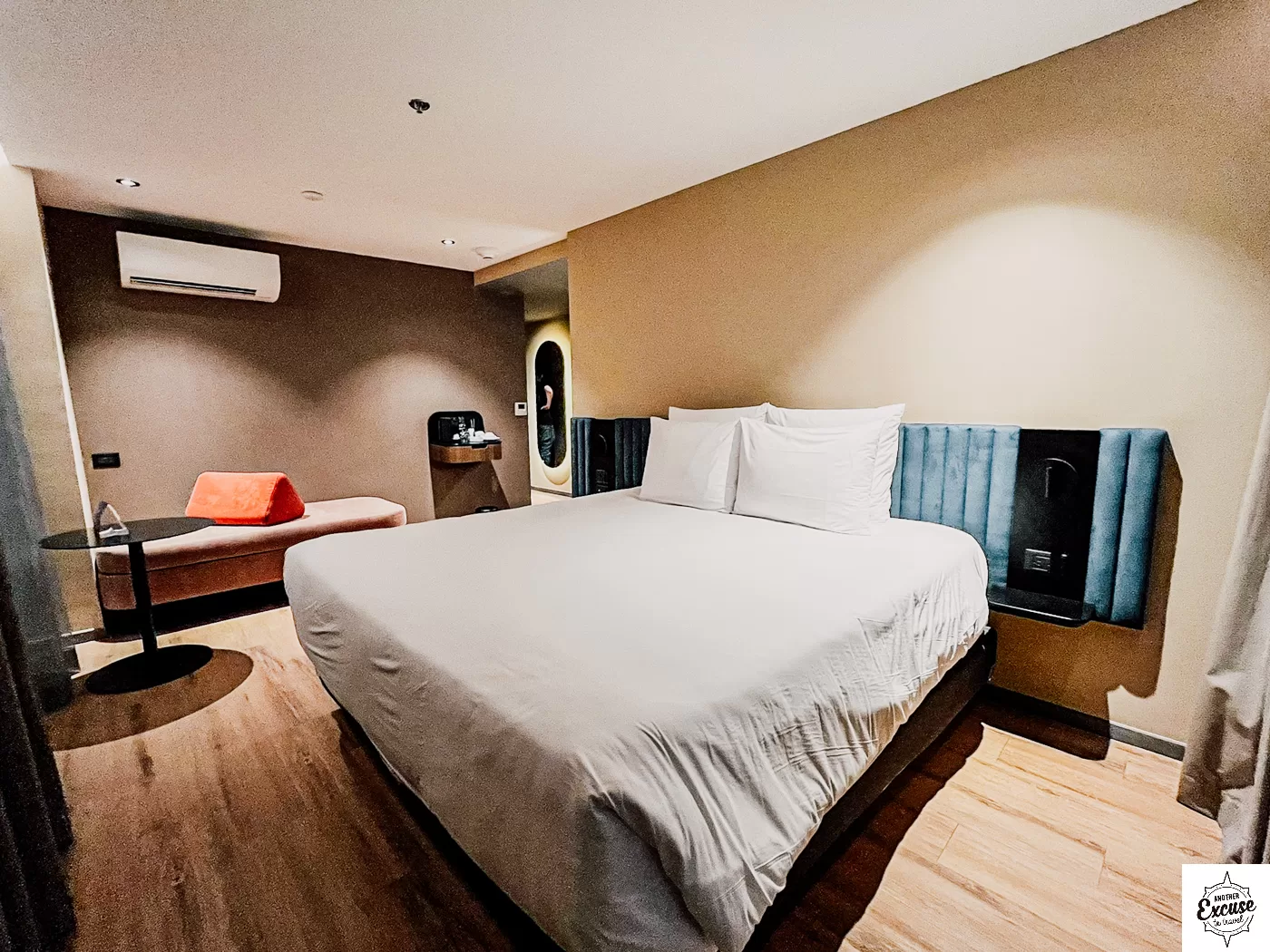 Hotel room with double bed and sofa.