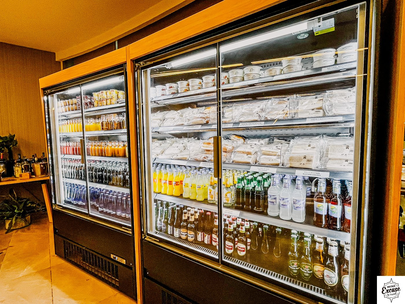 Airport lounge fridges with soft drinks, beer sandwiches and yoghurts.